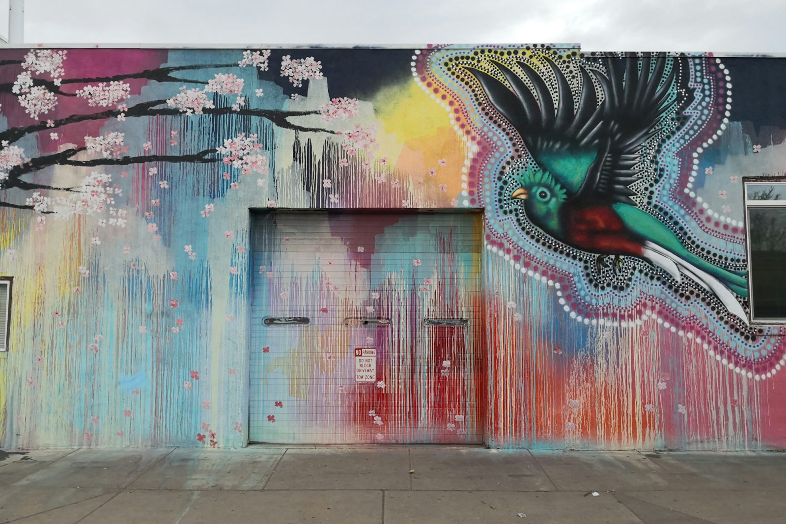 Mural-wrapped warehouse with creative-office approvals — mural-wrapped exterior