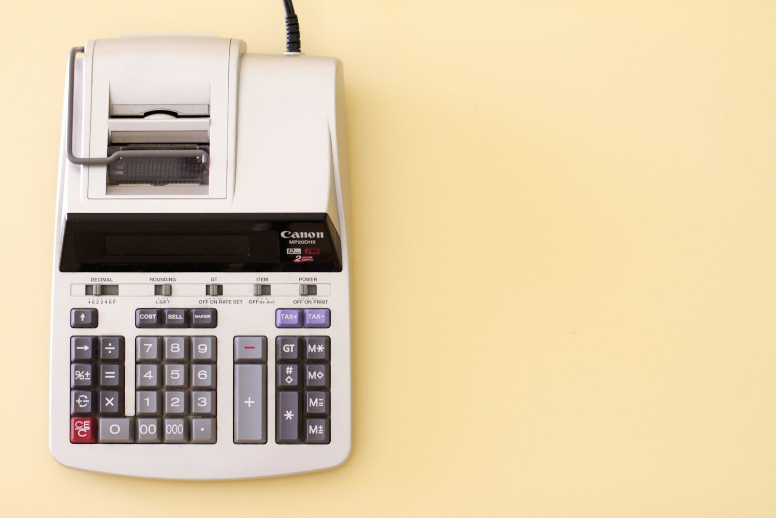 Desktop calculator on a yellow desk