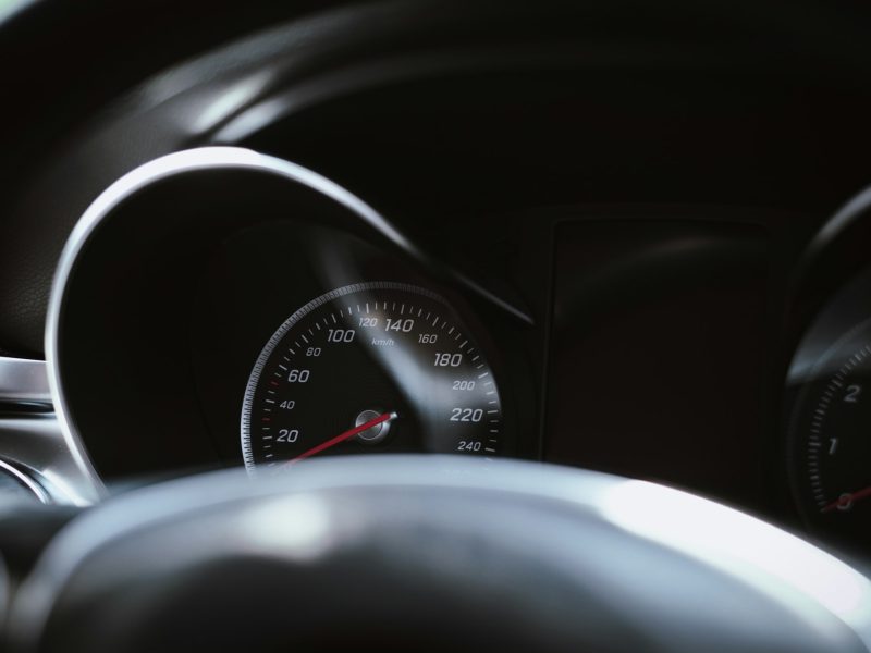 A car's dashboard speedometer is shown