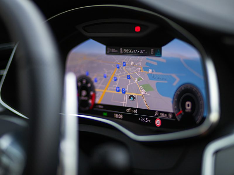 A close up of a car's dashboard with a gps