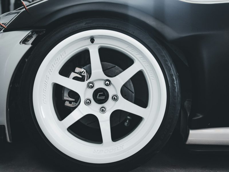 Close-up of a white car wheel with black tire