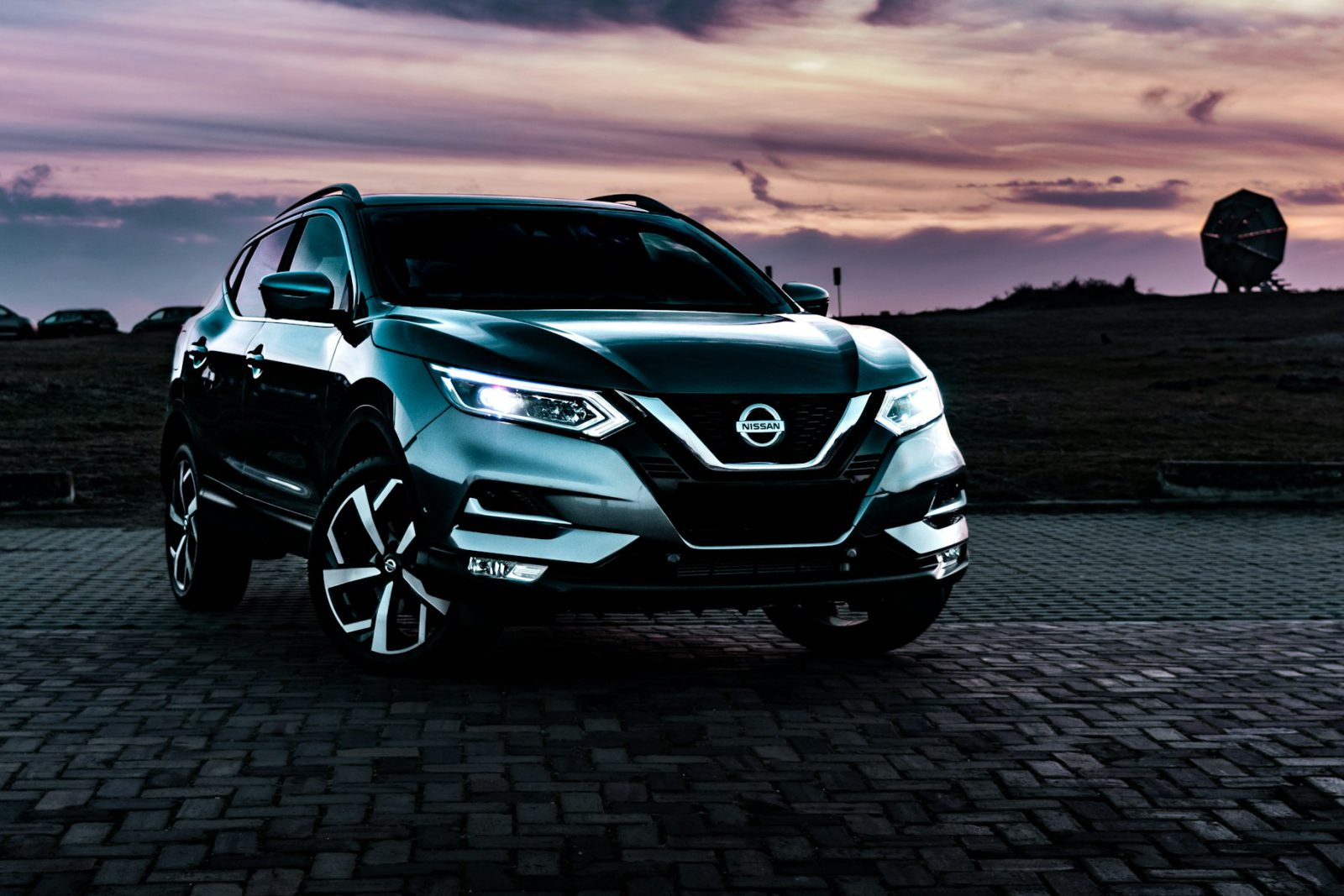 Gray Nissan Rogue Sport, front three-quarter view