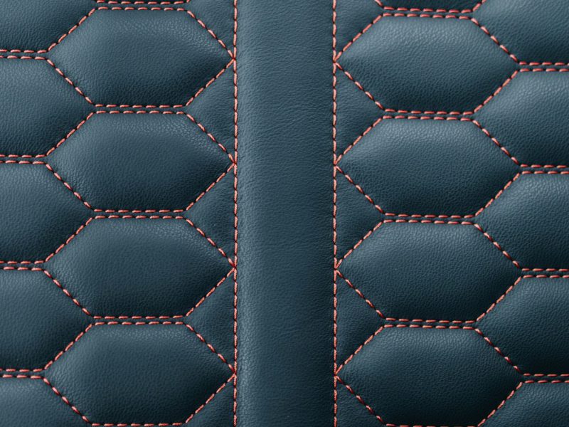 Hexagon-stitched leather seat upholstery with red thread