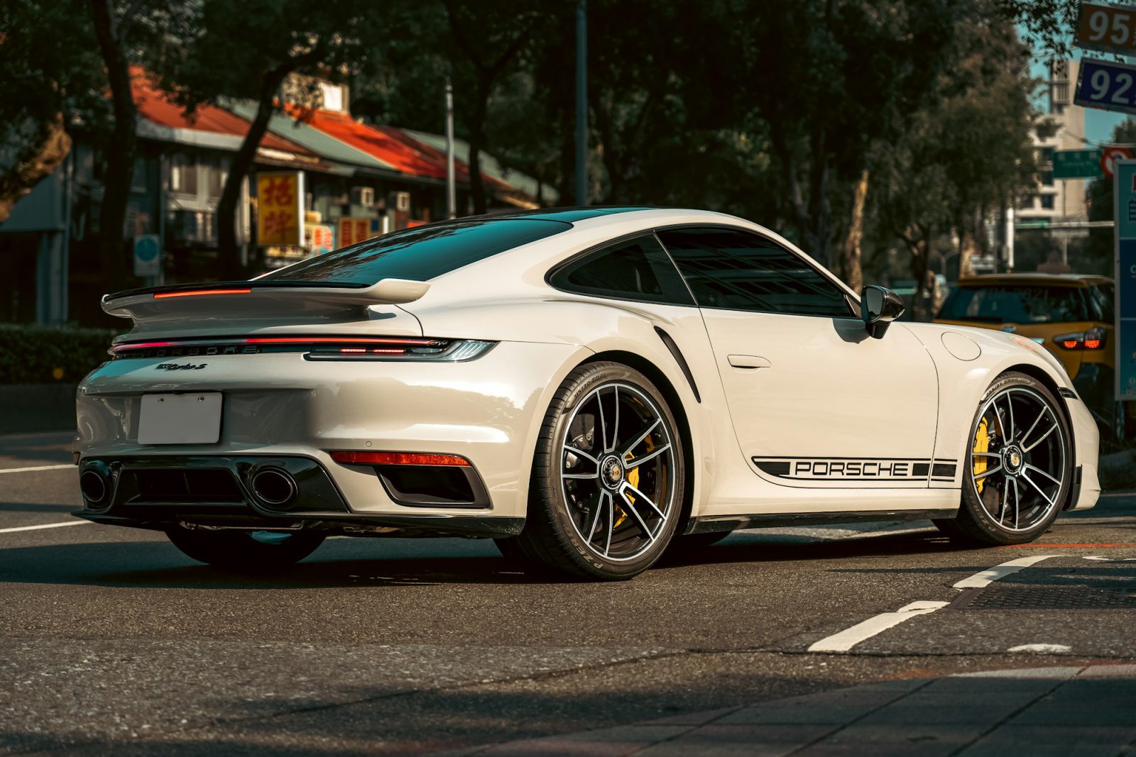 White Porsche 911, rear three-quarter view