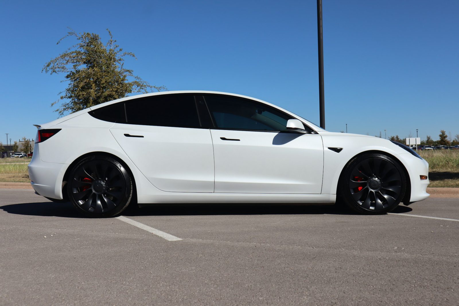 White Tesla Model 3, side profile
