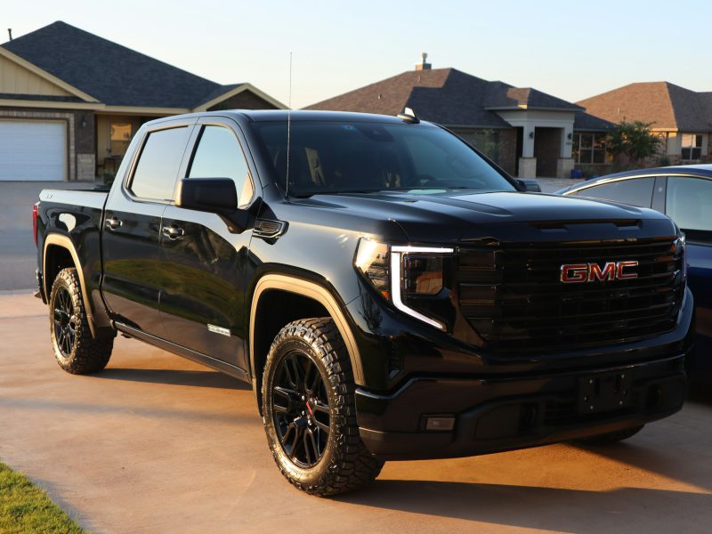 Black GMC Sierra, front three-quarter view