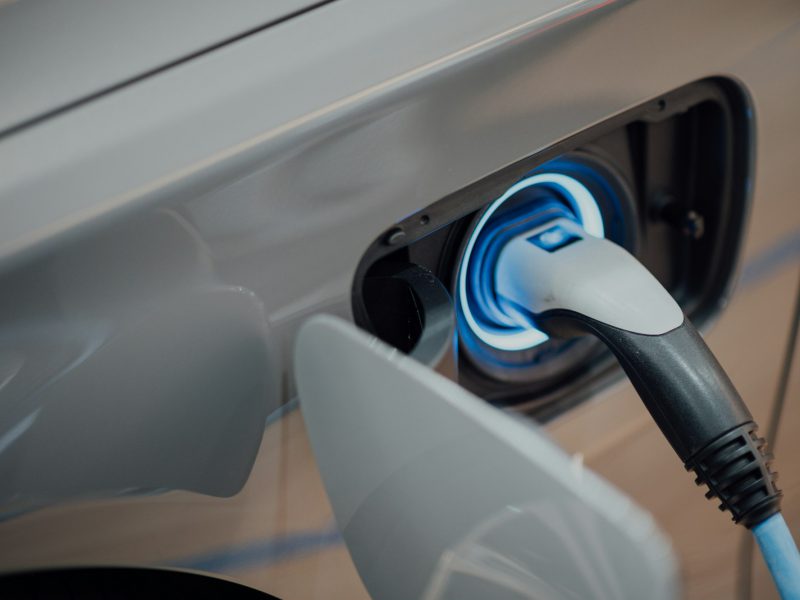 Electric vehicle charger plugged into car