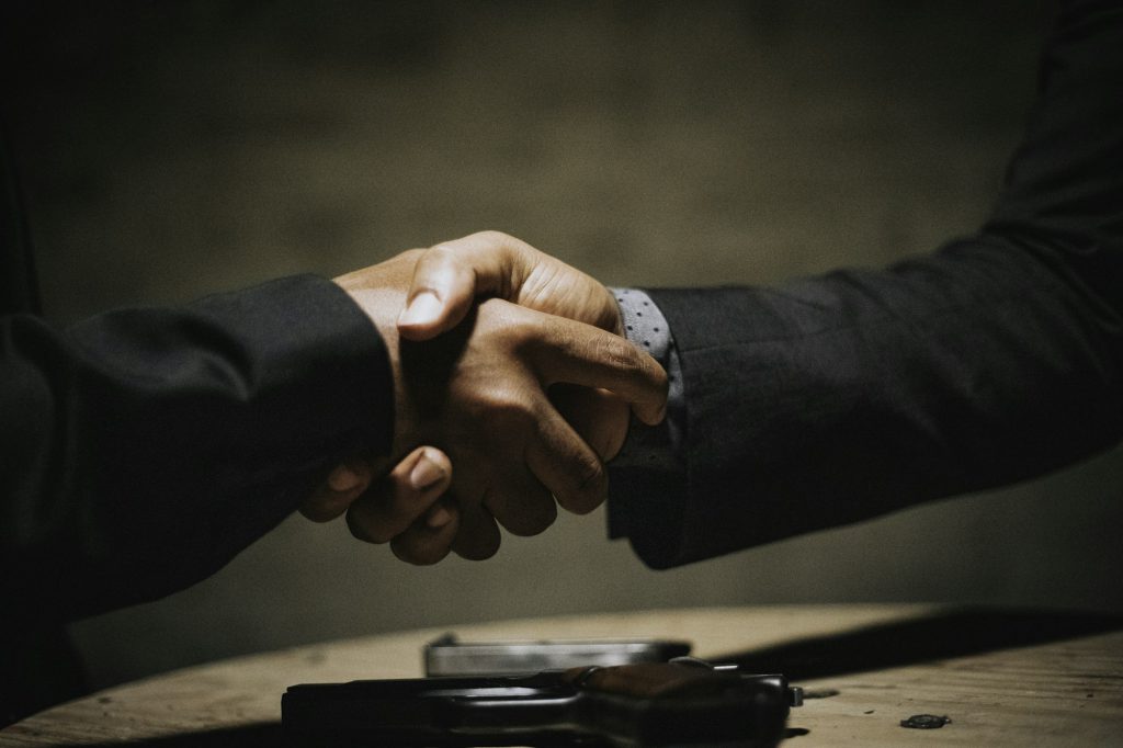 Handshake over a table with car keys