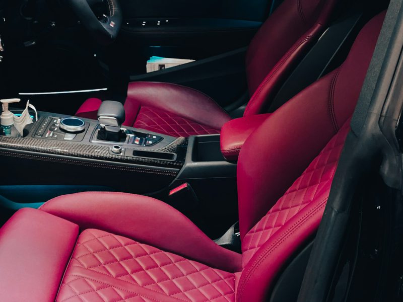 The interior of a car with red leather seats