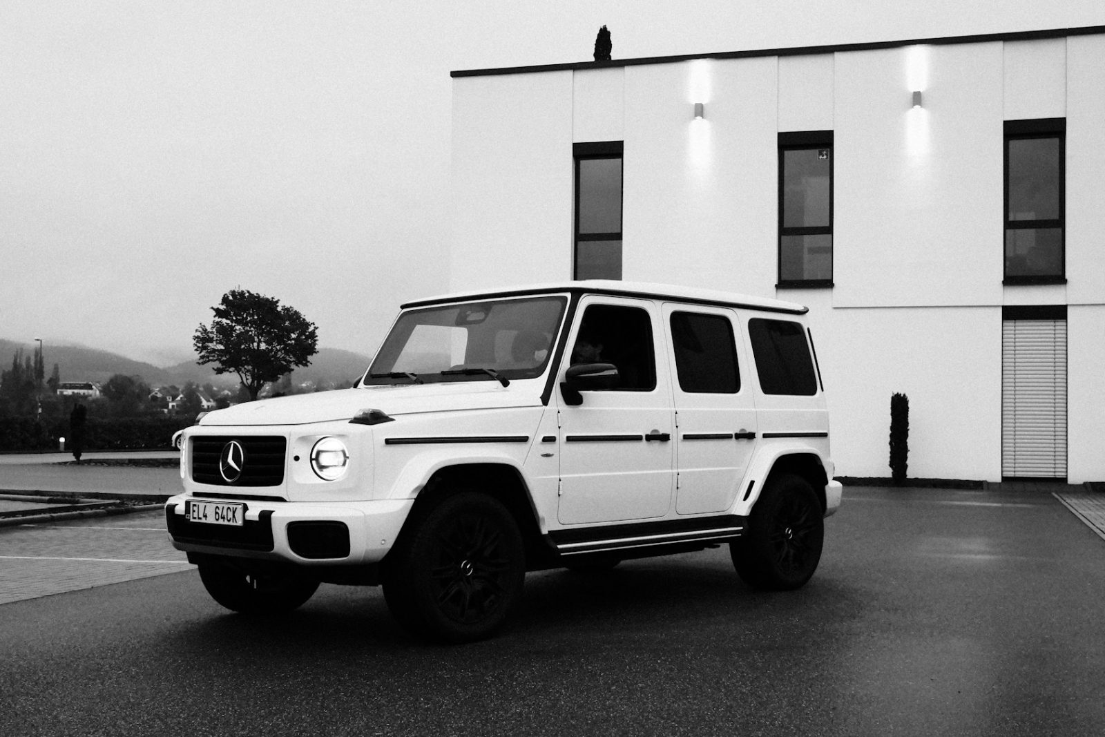 White Mercedes-Benz G-Class, front three-quarter view