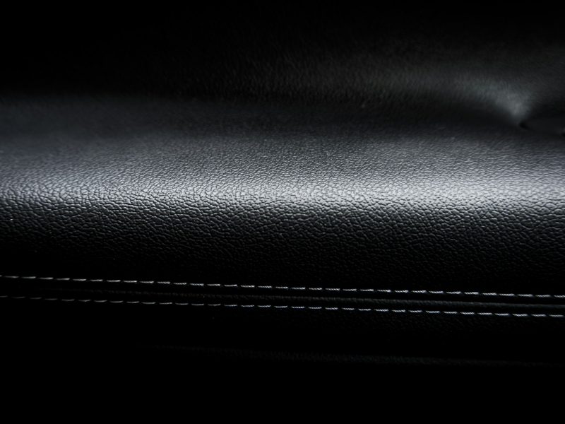 A close up of a black leather seat