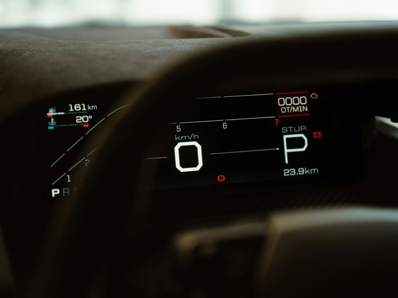 A close up of a car dashboard with a speedometer