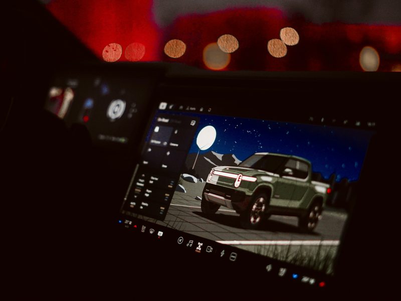 Car dashboard screen displaying a futuristic truck