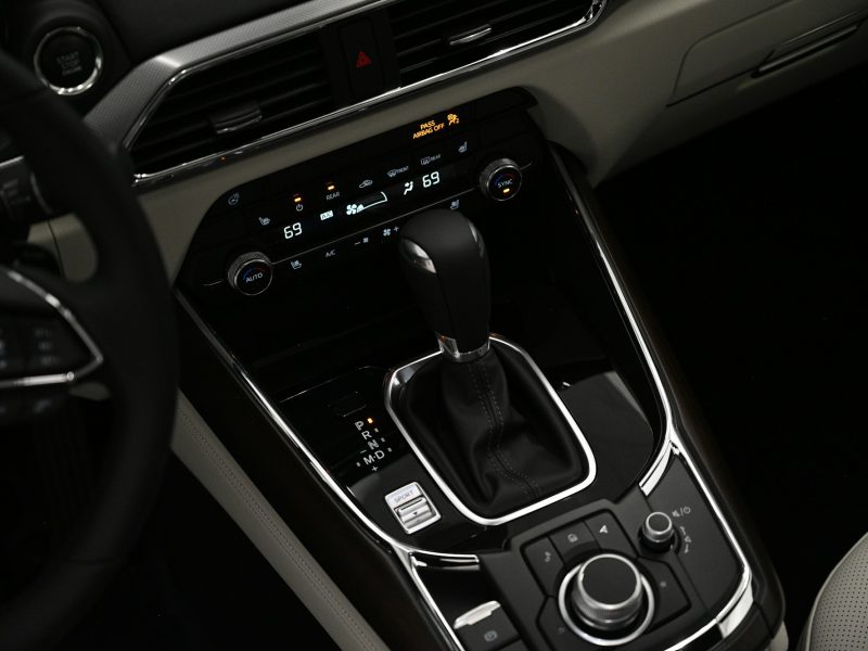 A close up of a car's dashboard with a steering wheel