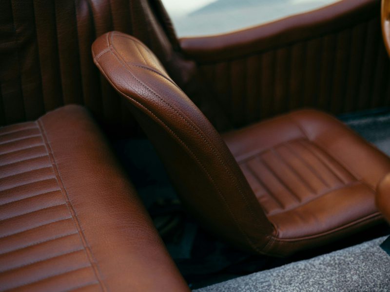 A close up of a car seat with a steering wheel