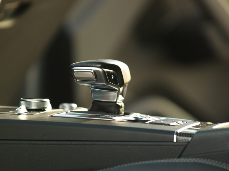 A modern car's automatic gear shifter and control panel