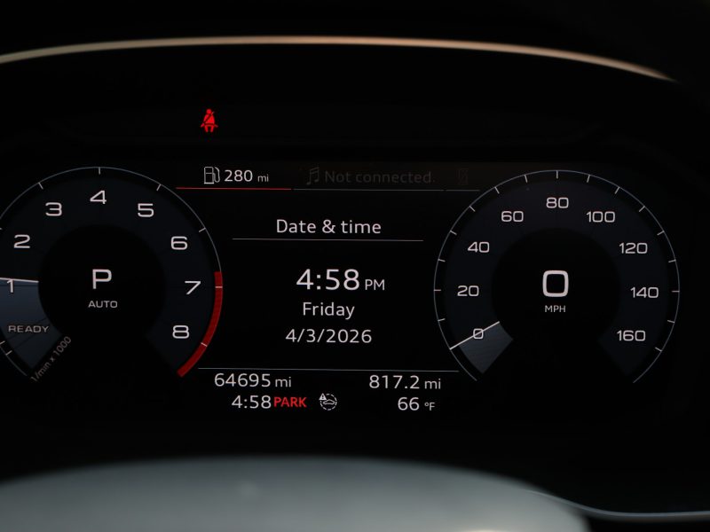 Car dashboard showing speed, date, and time