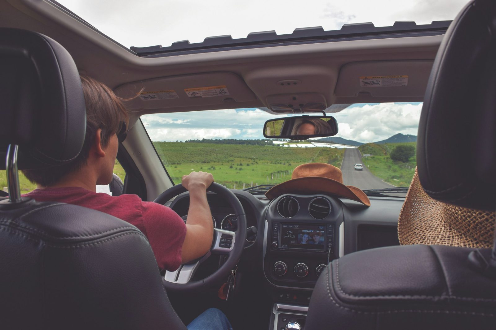 Driver steering through open countryside