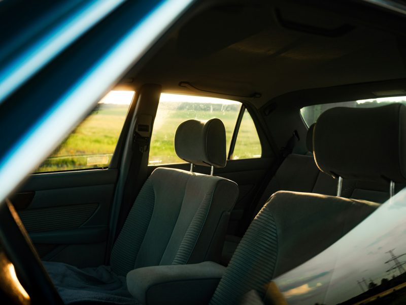The interior of a car with a view of a field