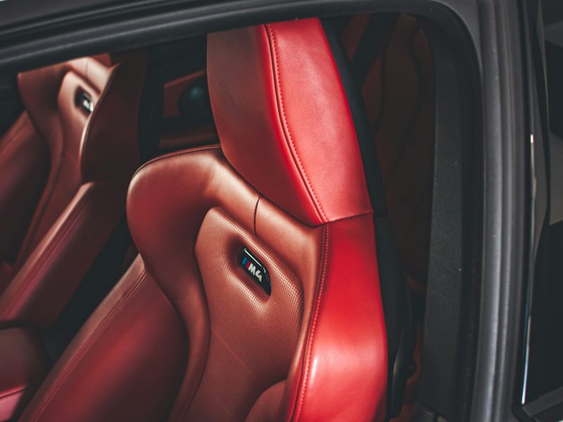 The interior of a car with red leather seats