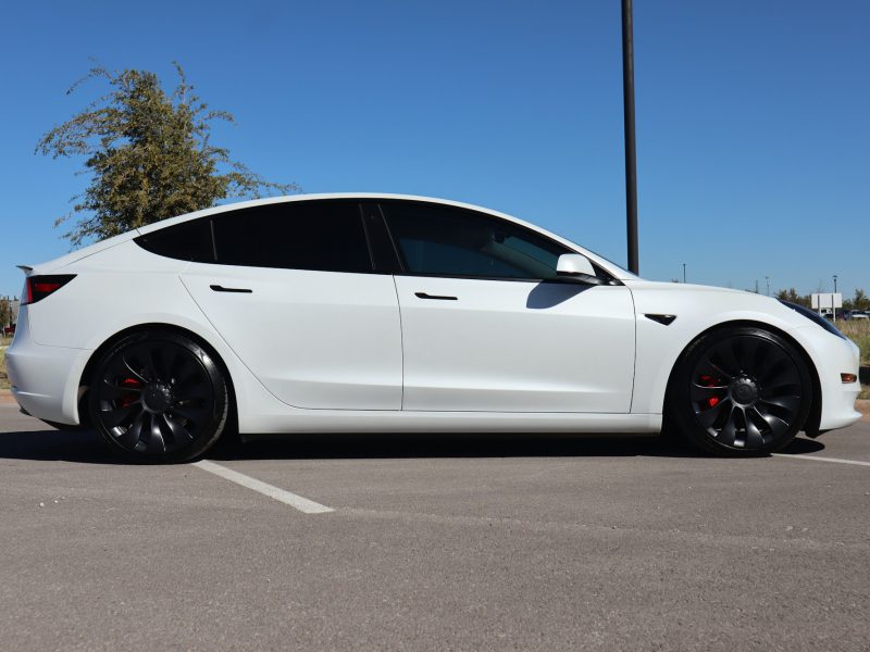 White Tesla Model 3, side profile