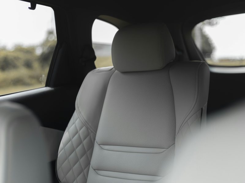 Light quilted front seat with a view of a field