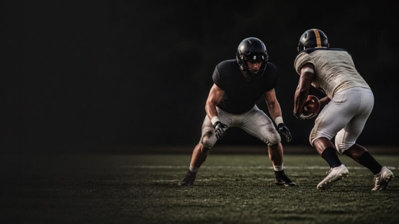 A linebacker squares up a ball carrier in open space.