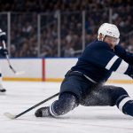Editorial illustration of a hockey defenseman blocking a shot in front of goal.