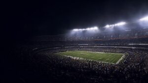 A full stadium at night seen from the end of the ground.