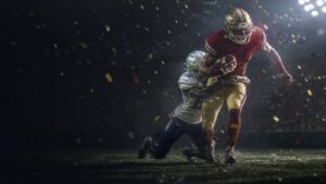 A running back in red and gold breaks a tackle under championship confetti.