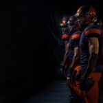 Players from both sides wait side by side in the tunnel.