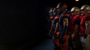 Players from both sides wait side by side in the tunnel.